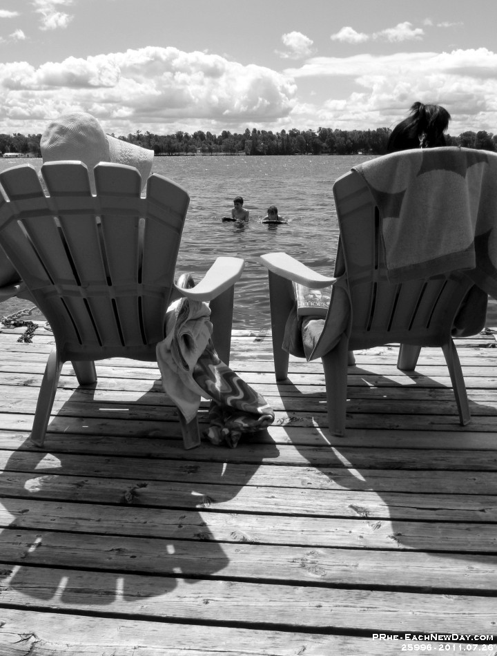 25996 c RoCrBwLe- Vacationing at the cottage - Kim, Stephanie - Julia relax on the dock while Beth - Andy boogie-board